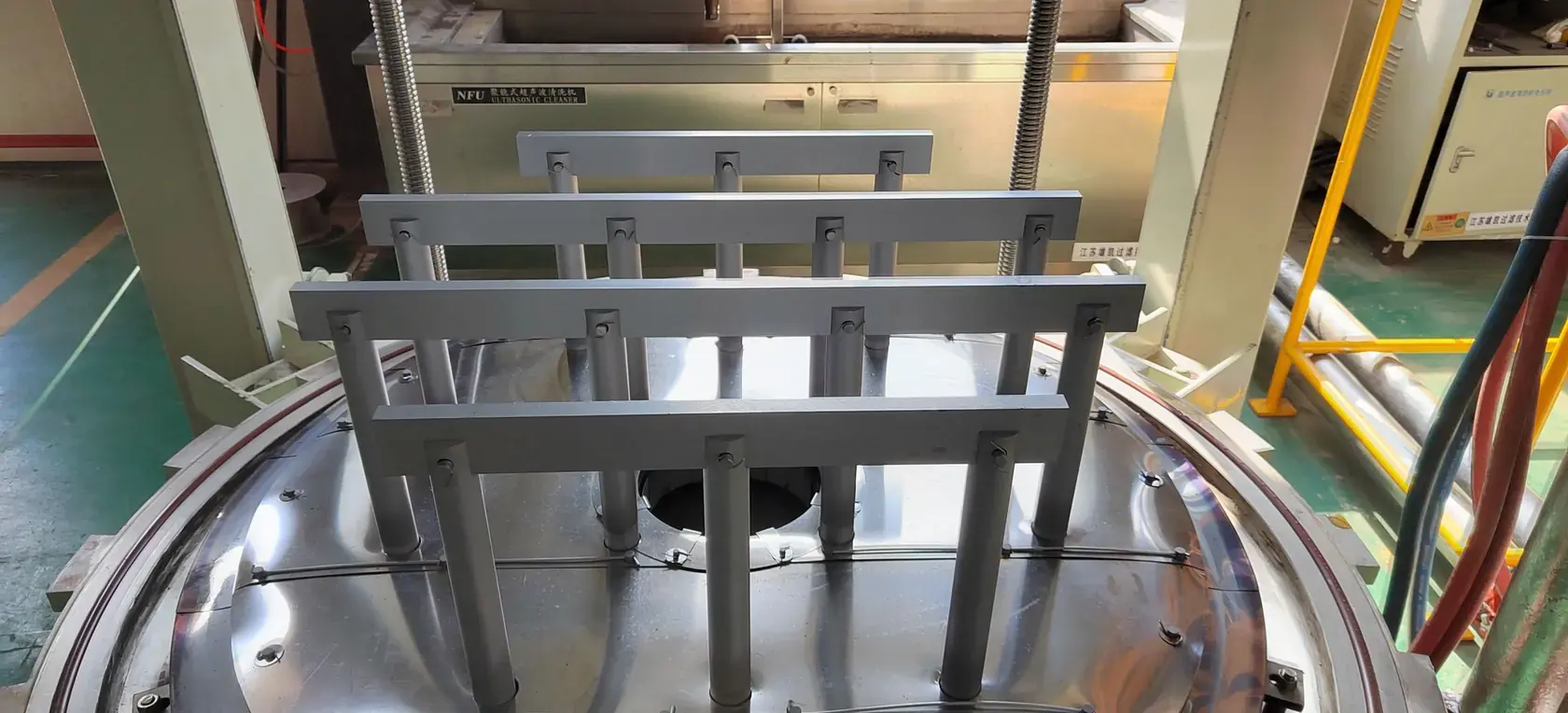 Work carrier raised beneath the chamber of a VTSL bottom-loading vacuum furnace