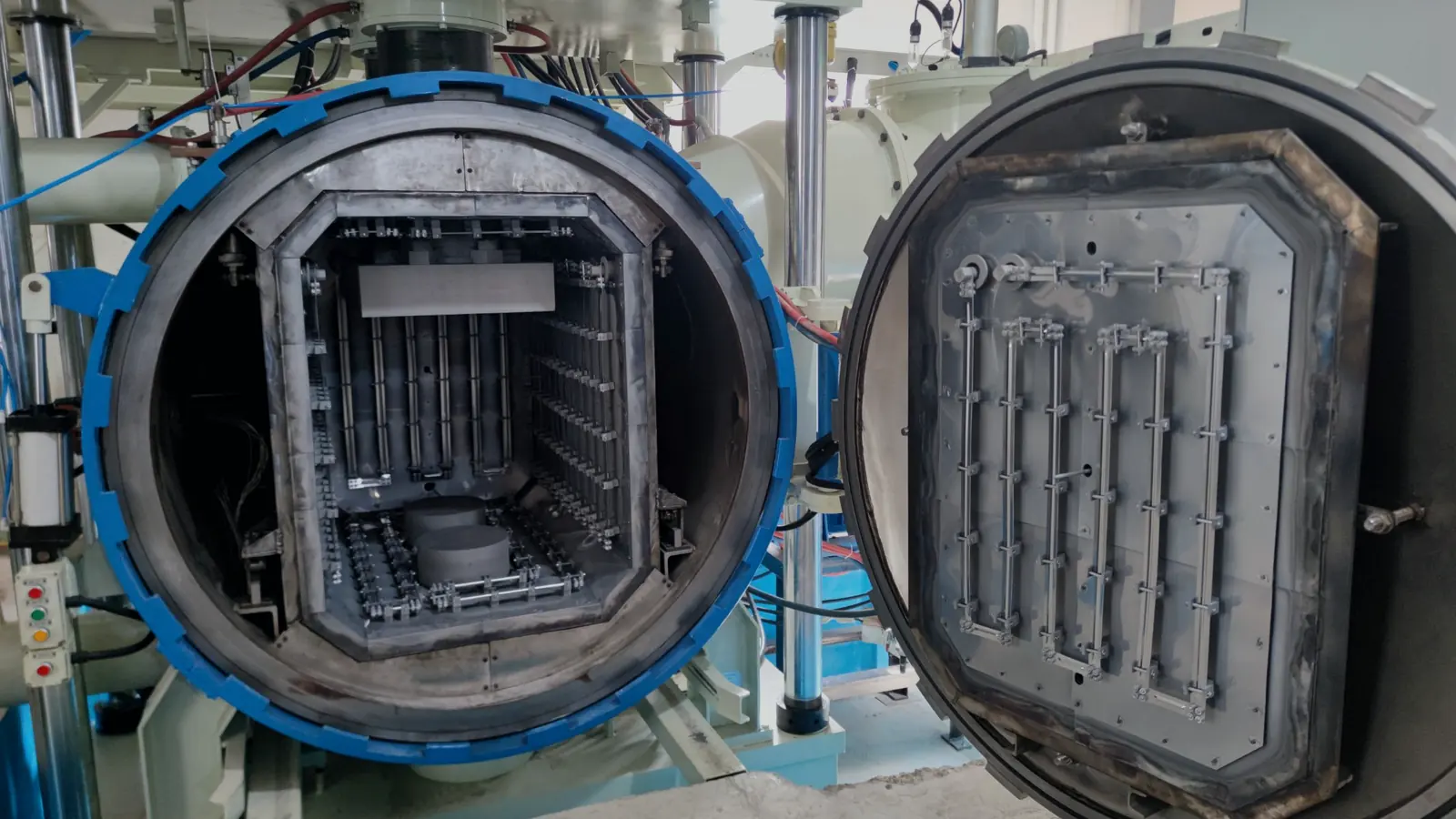 Open VTM-855 vacuum furnace chamber showing graphite hot zone and insulated door