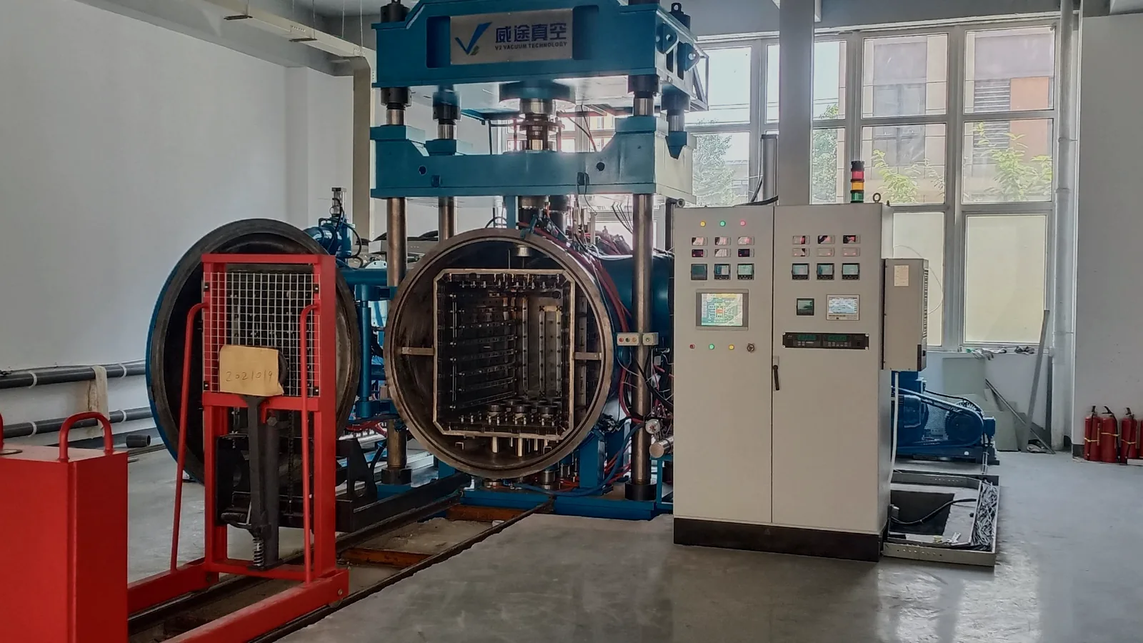 Open VTM-659 vacuum diffusion bonding furnace beside process control cabinets