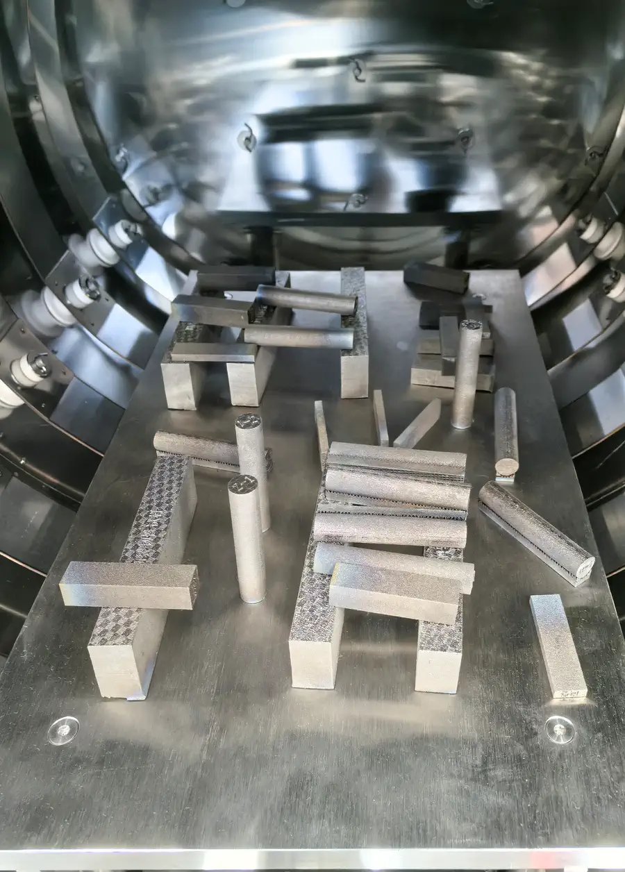 Additively manufactured metal samples arranged on setters inside the HVF-1350 furnace
